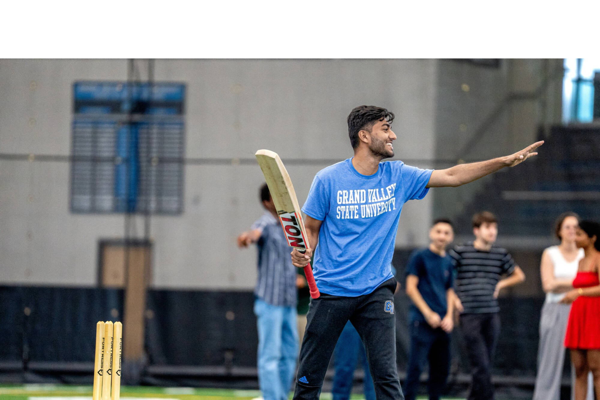 student playing cricket